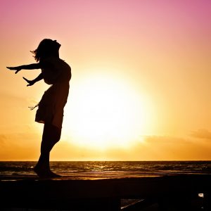 Woman breathing in the sun; 10 Ways to Build Resilience 
